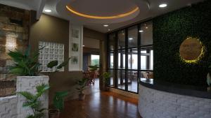 a lobby with a wall of plants and a counter at Lemon Hills Kuta in Kuta Lombok +3 photos