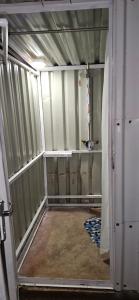 an unfinished room with a shower in a room at The Kimberlite Camping & Caravan Parking, Jwaneng in Jwaneng