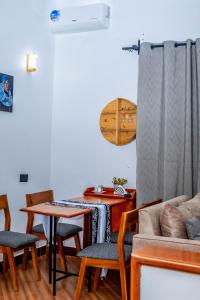 a living room with a table and chairs and a couch at Maggiez Leisure Home Dodoma in Dodoma