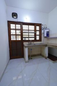 a kitchen with a sink and a large window at Imperial Home Stayz in Gurgaon
