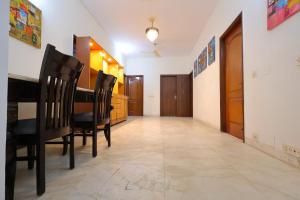 a dining room with a table and chairs at Imperial Home Stayz in Gurgaon +26 photos