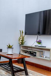 a living room with a tv and a coffee table at Maggiez Leisure Home Dodoma in Dodoma
