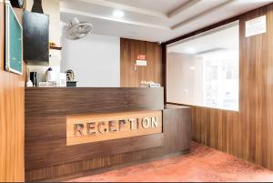 a reception desk with a sign that reads reception at The Seven Wonders Inn Hotel And Banquet in Lucknow