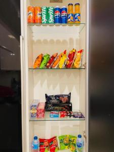 a refrigerator filled with lots of food and drinks at De Tabies Luxury Suites in Rawalpindi +4 photos