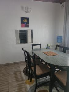 a dining room table and chairs in a room at RUWAMU Guesthouse in Naivasha +14 photos