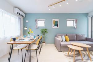 a living room with a table and a couch at 8 min to Nagoya Station Great access Sleeps 6 in Nagoya