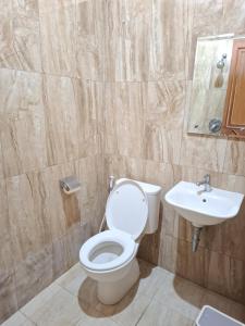 a bathroom with a toilet and a sink at Balkondes Tuksongo in Borobudur
