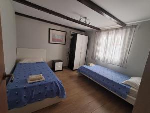 a bedroom with two beds with blue sheets at New renovated duplex near the ocean located in Tenerife Sur in Costa Del Silencio +53 photos