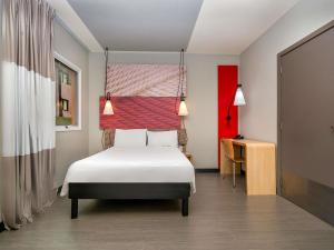 a bedroom with a white bed and a red wall at ibis Campo Grande in Campo Grande +53 photos
