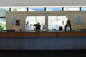 two people standing at a counter in an office at Casa Morena in Baceno