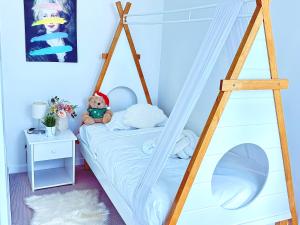 a bedroom with a canopy bed with a teddy bear at Central Comfort CBD 2BR Apartment with Pool and Gym SKT1002 in Brisbane