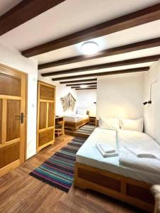a bedroom with a large bed and a desk at Vila Martina in Smilyan