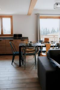 a kitchen and dining room with a table and chairs at Germain Ski Lodge in La Toussuire