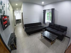 a living room with a couch and a table at Krabi Top Sea Hill Villa in Klong Muang Beach