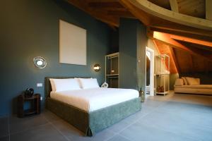 a bedroom with a large bed and a couch at Sky Room Mountain View - 3 min walk to Bernina Express in Tirano