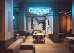 a restaurant with a table and chairs and a sign at City Hotel Thessaloniki in Thessaloniki