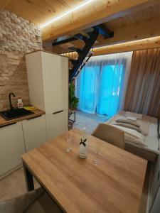 a kitchen with a table with two wine glasses on it at Bungalov Damiano's 9 in Podbrdo