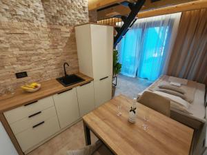 a kitchen with a counter and a table in a room at Bungalov Damiano's 9 in Podbrdo +1 photo
