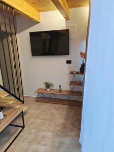a living room with a flat screen tv on the wall at Bungalov Damiano's 9 in Podbrdo