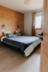 a bedroom with a large bed in a wooden room at Germain Ski Lodge in La Toussuire +27 photos