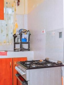 a kitchen with a stove top oven in a kitchen at Stivo apartment in Nakuru