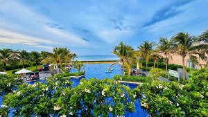 an aerial view of a resort with palm trees and a pool at Alexa Villa Cam Ranh - 3 Bedrooms, Private Pool, Beach Access in Cam Lâm