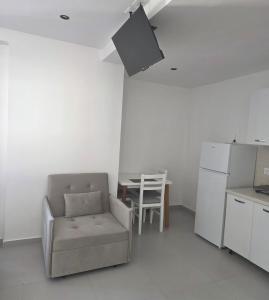 a kitchen with a chair and a table in a room at AJ GuestHouse in Tirana +8 photos