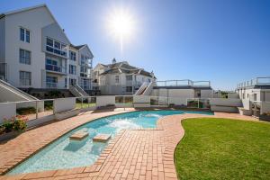 a swimming pool in the middle of a building at Ocean Whisper At 42 in Gqeberha