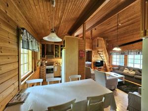 a kitchen and living room with a table and chairs at Koutakivi - Tilava mökki rinteen vieressä 2mh ja 2 parvea in Levi +9 photos