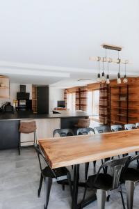 a dining room with a wooden table and chairs at Chalet Salt Lake in La Toussuire