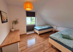 a room with two beds and a table and a window at Ferienwohnung Sunny 2 in Mittenwalde