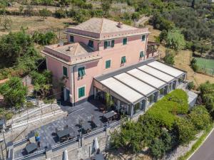 an aerial view of a pink house with a roof at Cava Ardè Rooms in Lavagna