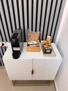 a white cabinet with a coffee maker on top of it at AWA boutique in Voluntari