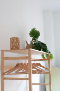 a wooden table with a plant on top of it at Tucano Mediceo Home in Pisa