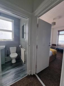 a bathroom with a toilet and a bed and a door at South Beach Kings Promenade Hotel in Blackpool +56 photos