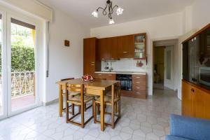 a kitchen with a table and chairs in a room at La casa di Sara in Cipressa