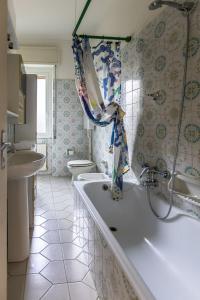 a bathroom with a tub and a toilet and a sink at La casa di Sara in Cipressa +19 photos