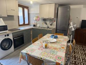 a kitchen with a table with a table cloth on it at Horizzonte Blu in Porto Alabe