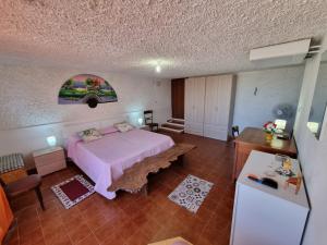 a bedroom with a bed and a table in it at Horizzonte Blu in Porto Alabe