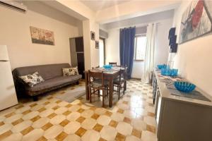 a living room with a couch and a table at Lavinia House in Oliveri