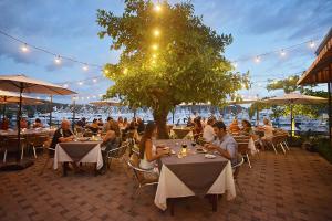 a group of people sitting at tables in a restaurant at Montecielo 4A 3 bdrs ocean view in Los Suenos in Herradura