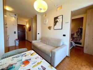a living room with a couch and a table at Studio with shared pool-Beahost in Porto Santa Margherita di Caorle