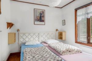 a bedroom with two beds and a window at KAL149-Fagerhult-Arhult-1-23 in Fagerhult