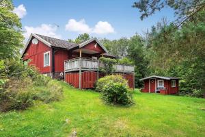a red house on top of a grassy hill at KAL149-Fagerhult-Arhult-1-23 in Fagerhult