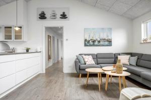 a living room with a couch and a table at FY396-Middelfart-Siriusvej-4 in Middelfart