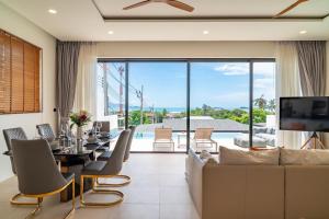 a living room with a dining table and a couch at 3-Bed Sea View Villa-Fisherman Village - KBR43 in Bophut 