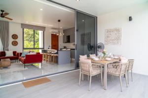 a kitchen and living room with a table and chairs at New 3BR Pool Villa in Bophut - KBR46 in Bang Rak Beach