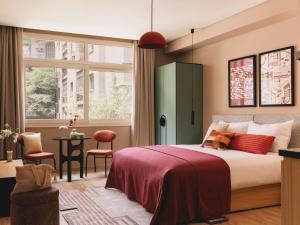 a bedroom with a bed and a green cabinet at Saint J Hotel by Brassbell in Cairo