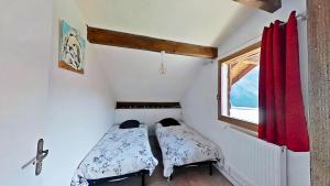 a small room with two beds and a window at CASA-2040 Family-Friendly Chalet Saint-Véran in Saint-Véran