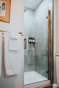 a shower with a glass door in a bathroom at The Underwood-Hale House in Providence +149 photos